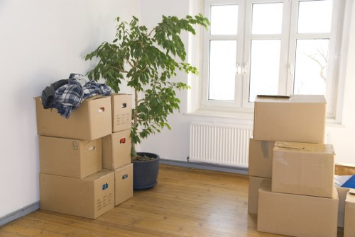 Professional movers handling flat removals in Northend near an apartment entrance